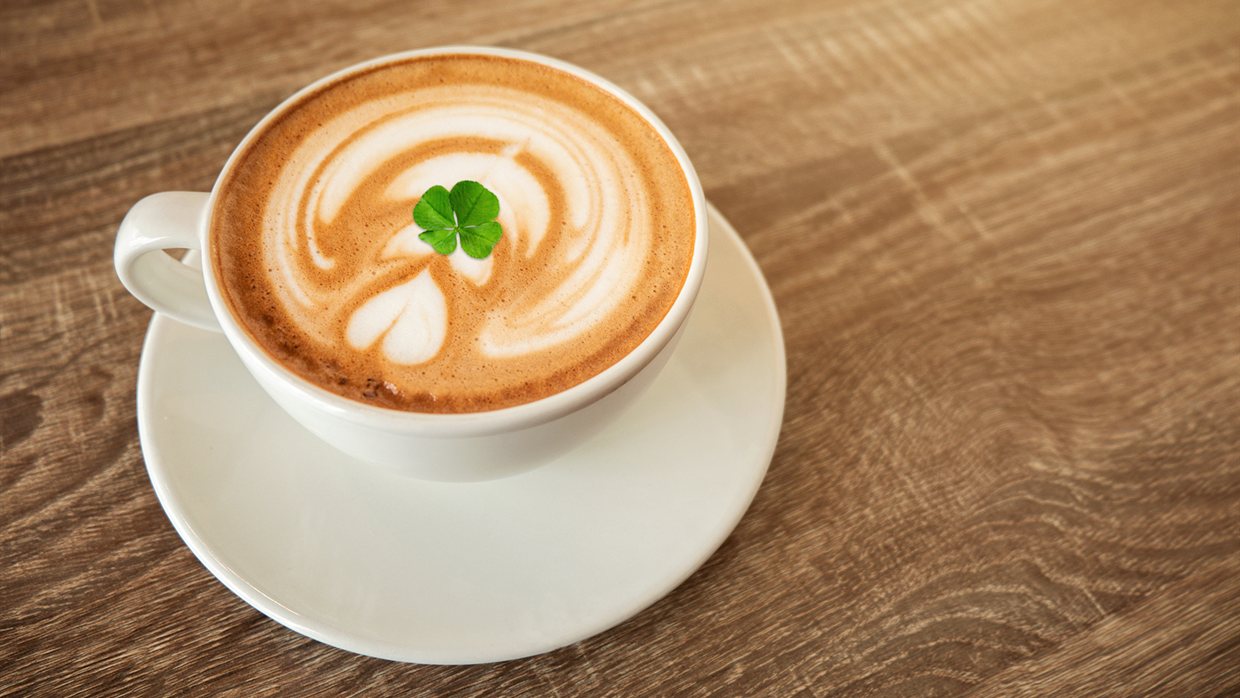 A real four-leaf clover served on a cappuccino